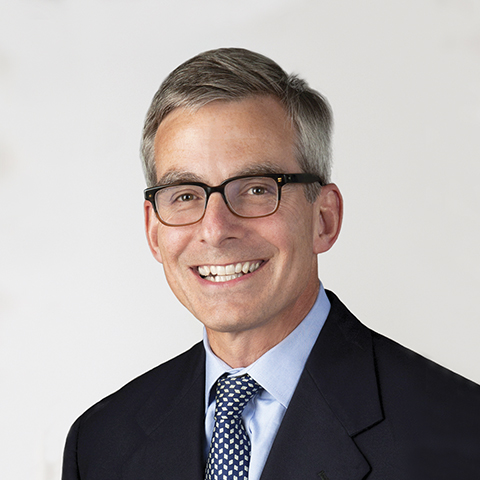 Terry Maxwell professional headshot with gray background.