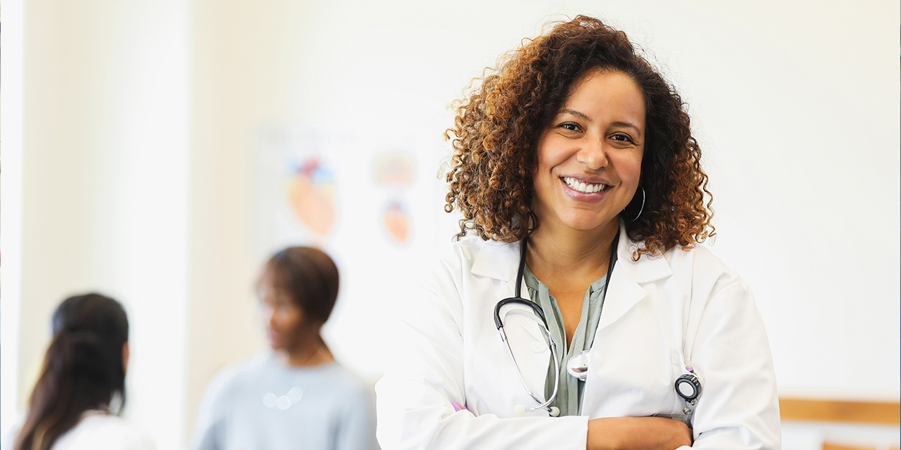 Femal medical professional with patient in background