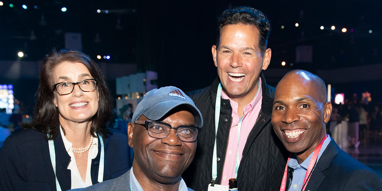 Four Baird Associates posting together at Baird event.